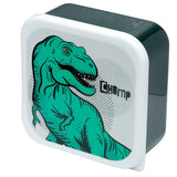Angled view of a dark green lunch box, showcasing its white, rounded lid with a vibrant green Tyrannosaurus Rex illustration, open-mouthed with visible teeth, and the word 'CHOMP'.
