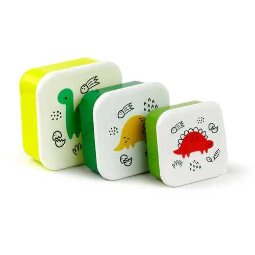 Angled view of a set of three square lunch boxes, featuring white lids with cartoon green, yellow, and red dinosaur illustrations, and contrasting light green, dark green, and lime green bases, on a white background.