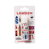 Front view of a white strawberry stick lip balm in London souvenir-themed blister packaging. The lip balm features colourful illustrations of iconic London landmarks, with LONDON and Strawberry Lip Balm text visible on the card.