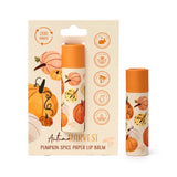 Front view of an Autumn Harvest Pumpkin Spice paper stick lip balm. One cylindrical lip balm, decorated with autumnal pumpkin illustrations, is presented within its matching retail card packaging. Another identical lip balm stands freely beside it. The packaging features 'Autumn HARVEST' text and icons for 'Zero Waste', 'Cruelty Free', and 'Plastic Free'.