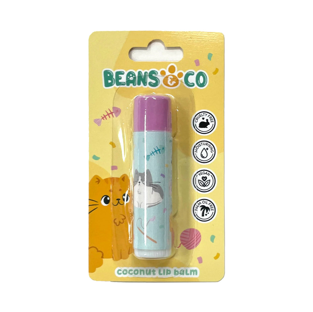 Front view of a stick lip balm in bright yellow card packaging, featuring an orange cat illustration and a light blue lip balm tube with a purple cap. The tube is decorated with white and grey cats and fish bones, with visible text indicating coconut flavour, cruelty-free, and vegan.