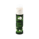 Front view of a dark green paper stick lip balm featuring a Moomin garden life illustration and 'Garden Life in Moomin Valley' text, with the white lip balm stick extended.