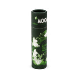 Angled view of a dark green paper stick lip balm tube, featuring white and light green illustrations of Moomin characters, garden foliage, and butterflies, with partial visible text 'MOO' and 'GARDEN LIFE'.