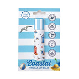 Front view of a paper stick lip balm with a blue and white striped cap and coastal illustrations of beach huts, seagulls, and a sailboat, displayed on a matching blue and white striped backing card featuring 'Coastal Vanilla Lip Balm' text, 'Zero Waste', 'Cruelty Free', 'Vegan', 'Palm Oil Free', 'Moisturising', and 'Plastic Free' badges.