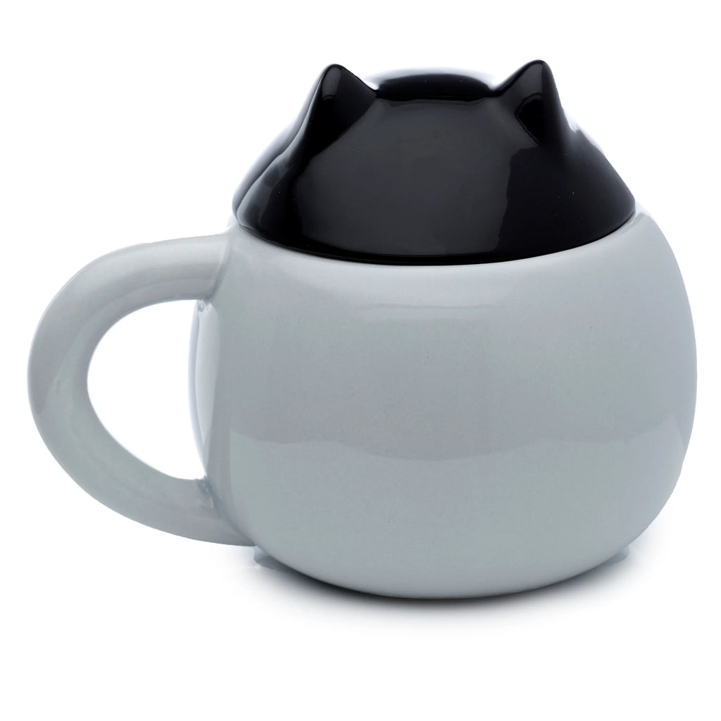 Rear view of a round, light grey ceramic mug with a black lidded top featuring two pointy cat ears, with the handle visible on the left.