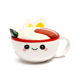 Front view of a white ceramic lidded mug with a red rim, featuring a happy cartoon face, and a ramen-style lid decorated with white noodles, two boiled egg halves, green garnish, and a brown stripe.