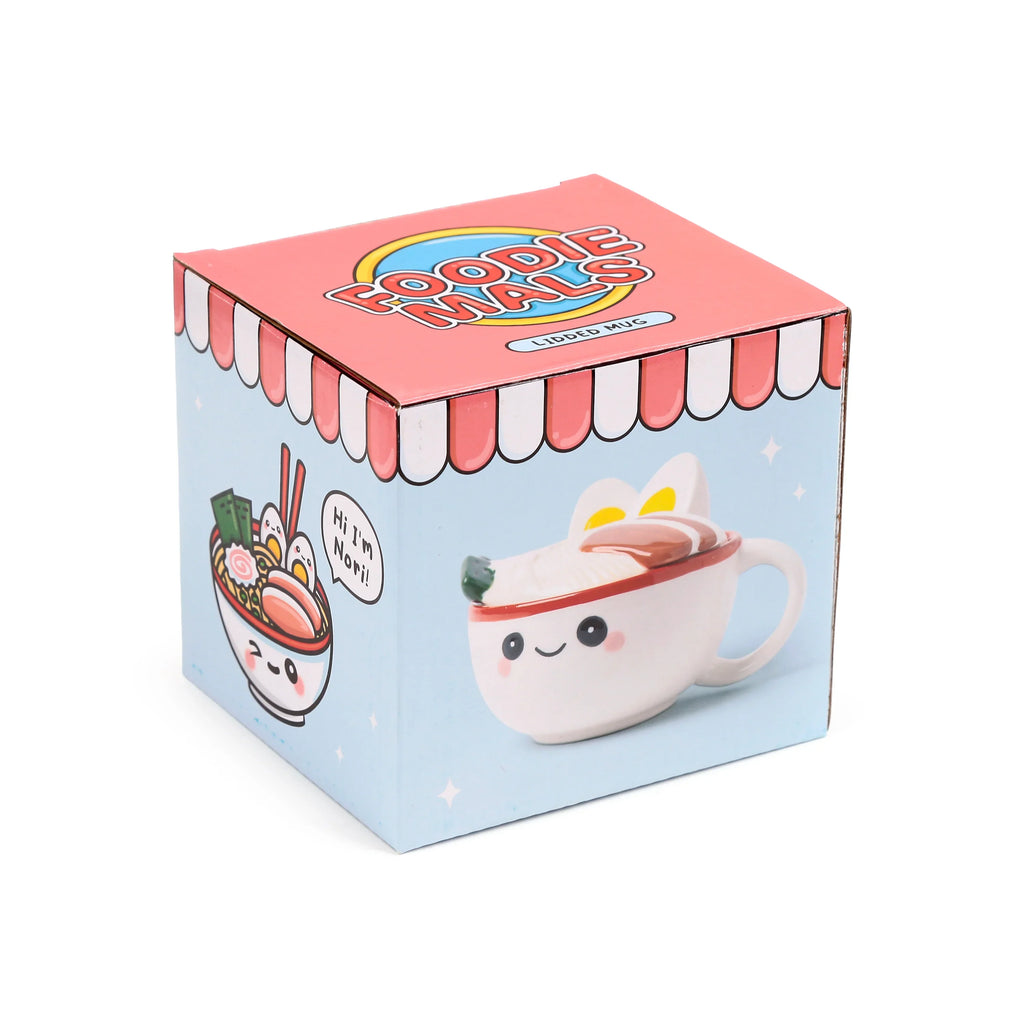 Angled view of a light blue and pink 'Foodiemals' ceramic lidded mug packaging box, featuring cartoon illustrations of a ramen bowl character named Nori and the white ramen-themed mug with its lid.