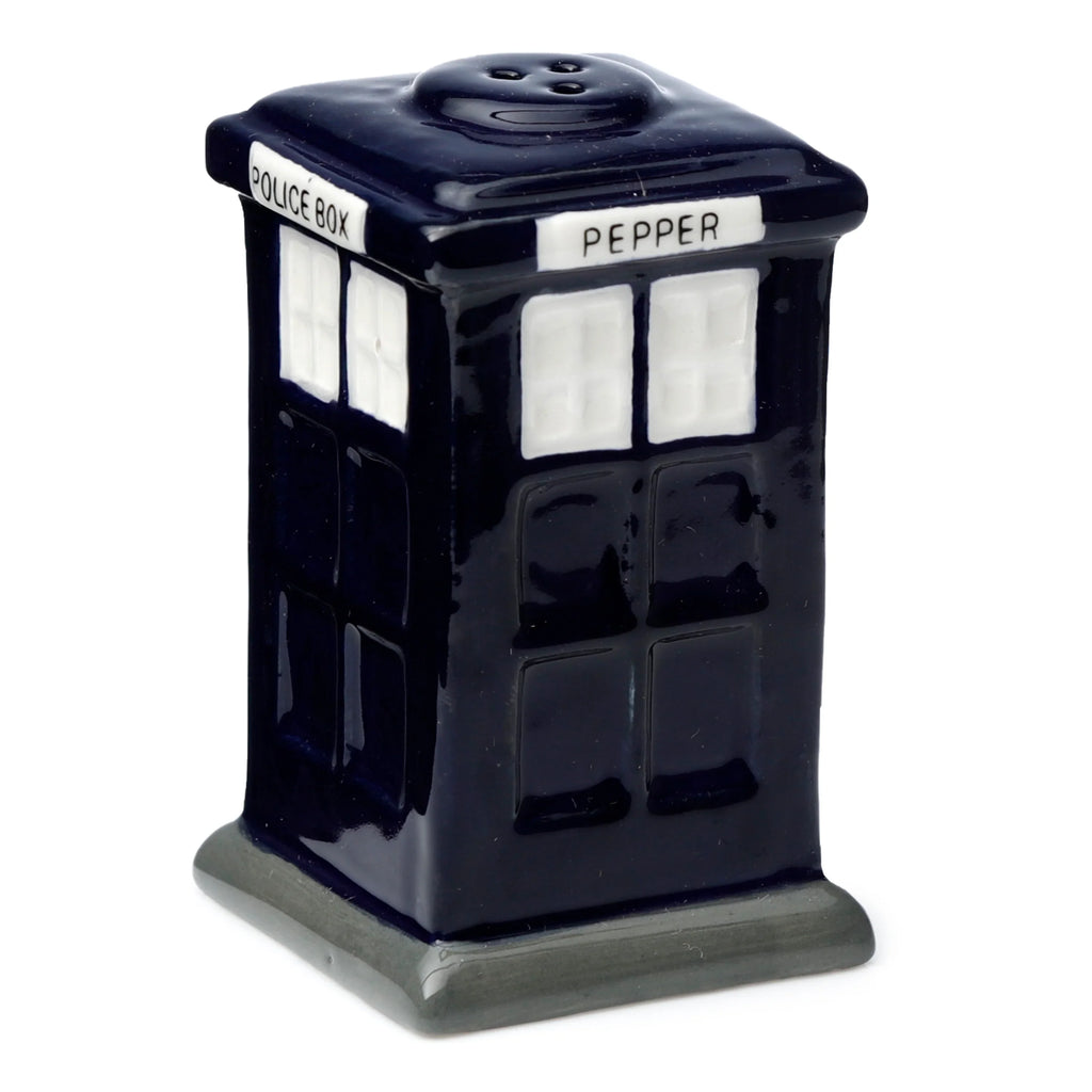 Angled view of a glossy dark blue ceramic pepper shaker, shaped like a police box, with a darker grey base. It features white rectangular window details and white text on visible sides, reading PEPPER and POLICE BOX. Three dispensing holes are visible on the top.