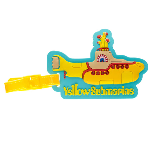 Front view of a yellow and blue PVC luggage tag, shaped like The Beatles' Yellow Submarine, with 'Yellow Submarine' text, red and beige details, and a yellow attachment strap.