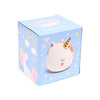 Angled view of a light blue money box packaging, featuring a white unicorn, golden horn, pink details, rainbows, hearts, and stars. The lid displays 'Unicorn Magic Money Box' text.