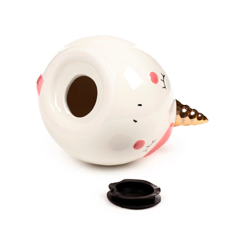 White ceramic unicorn money box, angled view showing the coin slot, golden horn, and a removed black plug.