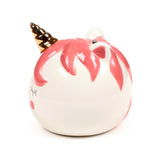 Angled view of a white ceramic unicorn money box featuring a golden horn, pink mane, pink cheeks, closed eyes, and a coin slot on top.