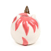 Angled top-down view of a white ceramic unicorn money box with a golden spiral horn, small ears, and pink markings radiating from the top, showing the coin slot.
