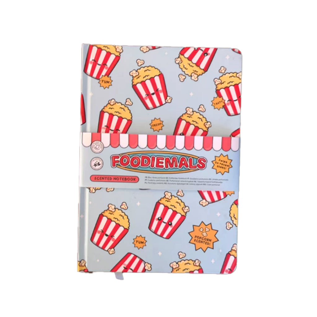 Front view of a Foodiemals scented notebook. Its light blue cover displays a repeating pattern of cartoon popcorn buckets with faces, wrapped with a red and white striped 'SCENTED NOTEBOOK' band.
