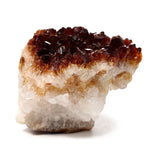 Front view of a natural gemstone crystal cluster with dark amber points and a white base.