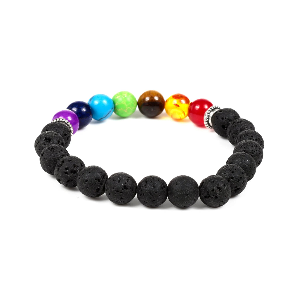 Angled view of a Chakra gemstone bracelet, featuring seven colourful beads and textured black lava rock beads.