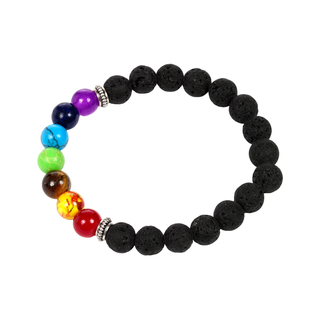 Overhead view of a chakra gemstone and lava rock bracelet. The stretch bracelet features porous black lava beads and seven smooth, colourful beads in red, yellow, brown, green, turquoise, dark blue, and purple, accented with silver-coloured spacers. It is arranged in an oval shape on a white background.