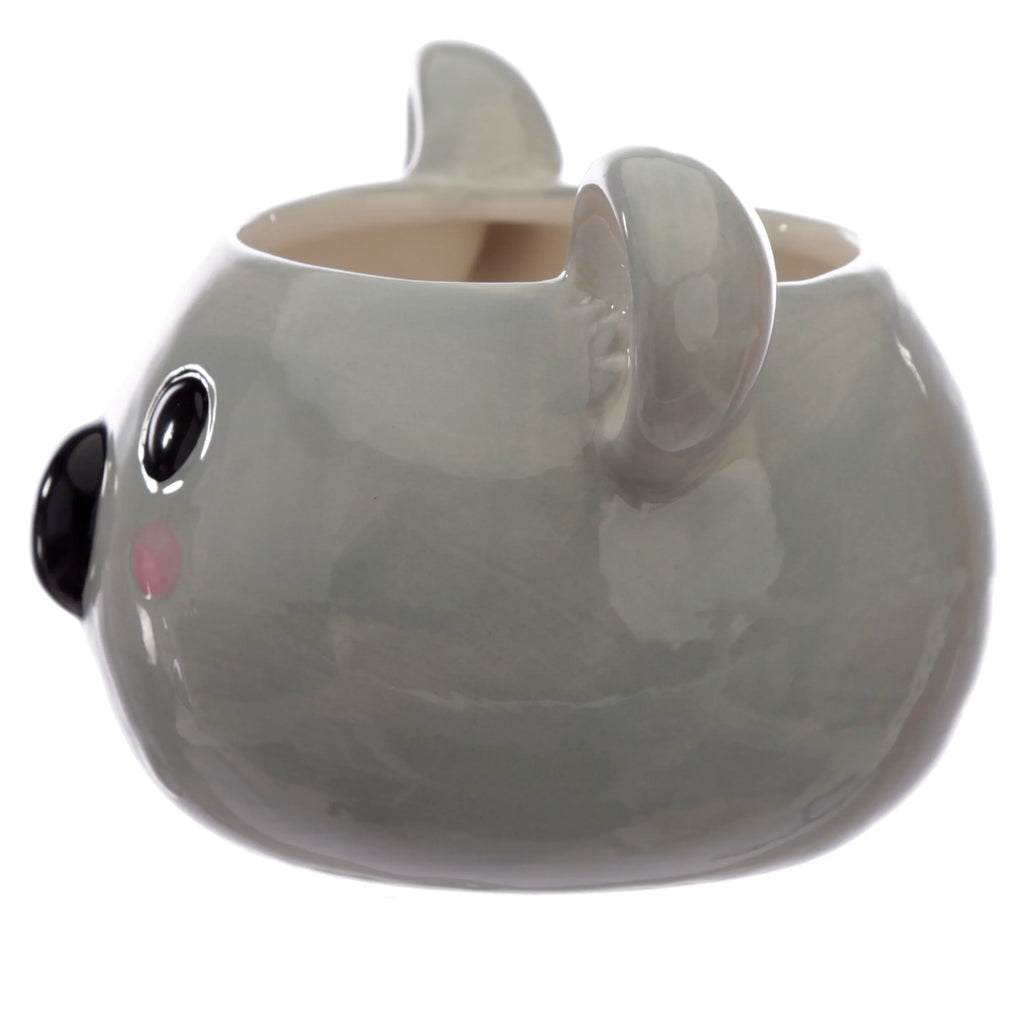 Angled view of a grey ceramic koala head mug with black eyes, a black nose, pink cheeks, and ears.