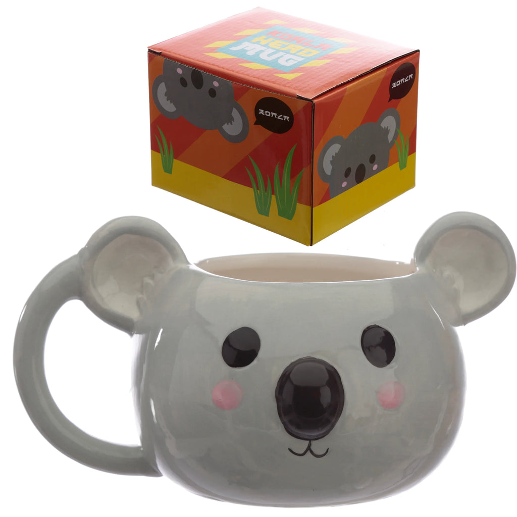 Front view of a glossy grey ceramic koala shaped mug with large ears, black eyes, black nose, and pink cheeks, displayed alongside its angled red and yellow retail box showing a cartoon koala and 'Koala Head Mug' text.