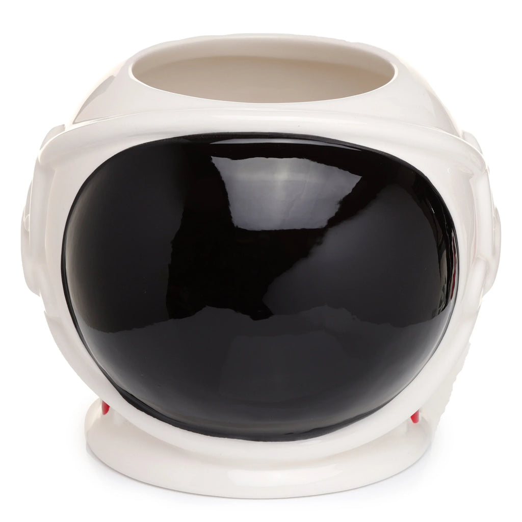 Front view of a white ceramic mug shaped like an astronaut's space helmet, featuring a large black visor and small red accents.