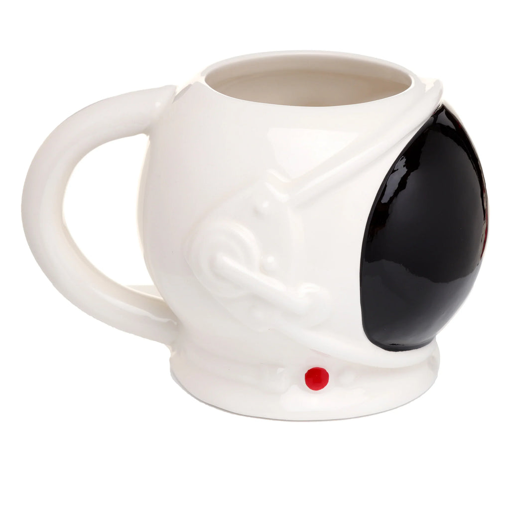 Angled view of a white ceramic astronaut space helmet mug, featuring a glossy black visor, raised sculpted details on the side, a small red circular accent, and its handle.