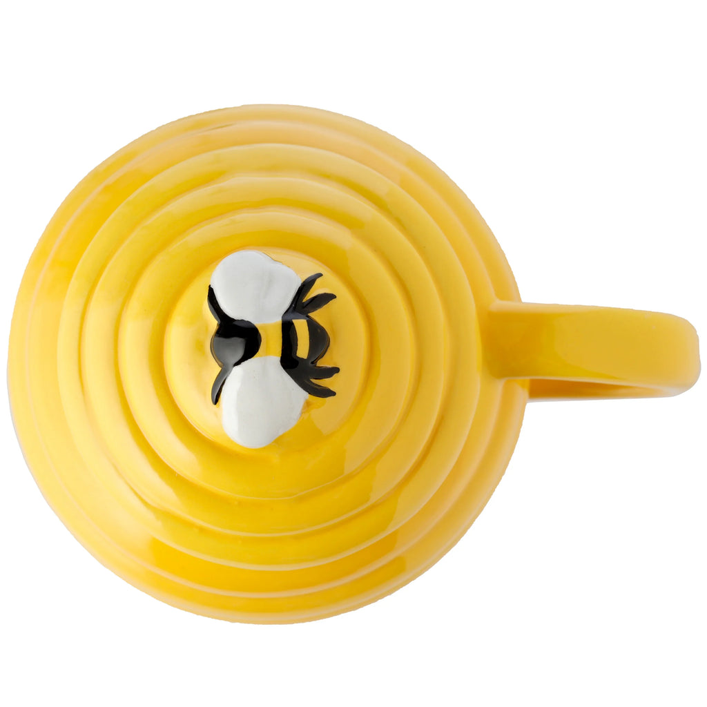 Top-down view of a vibrant yellow beehive-shaped ceramic mug, featuring a ribbed surface and a black and white bee decoration.
