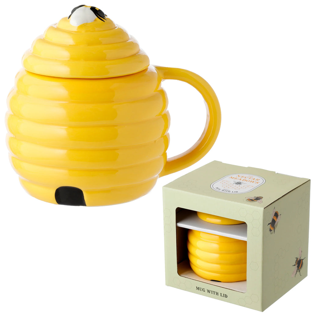 Yellow beehive ceramic mug with a bee-decorated lid and handle, presented next to its light green packaging box.