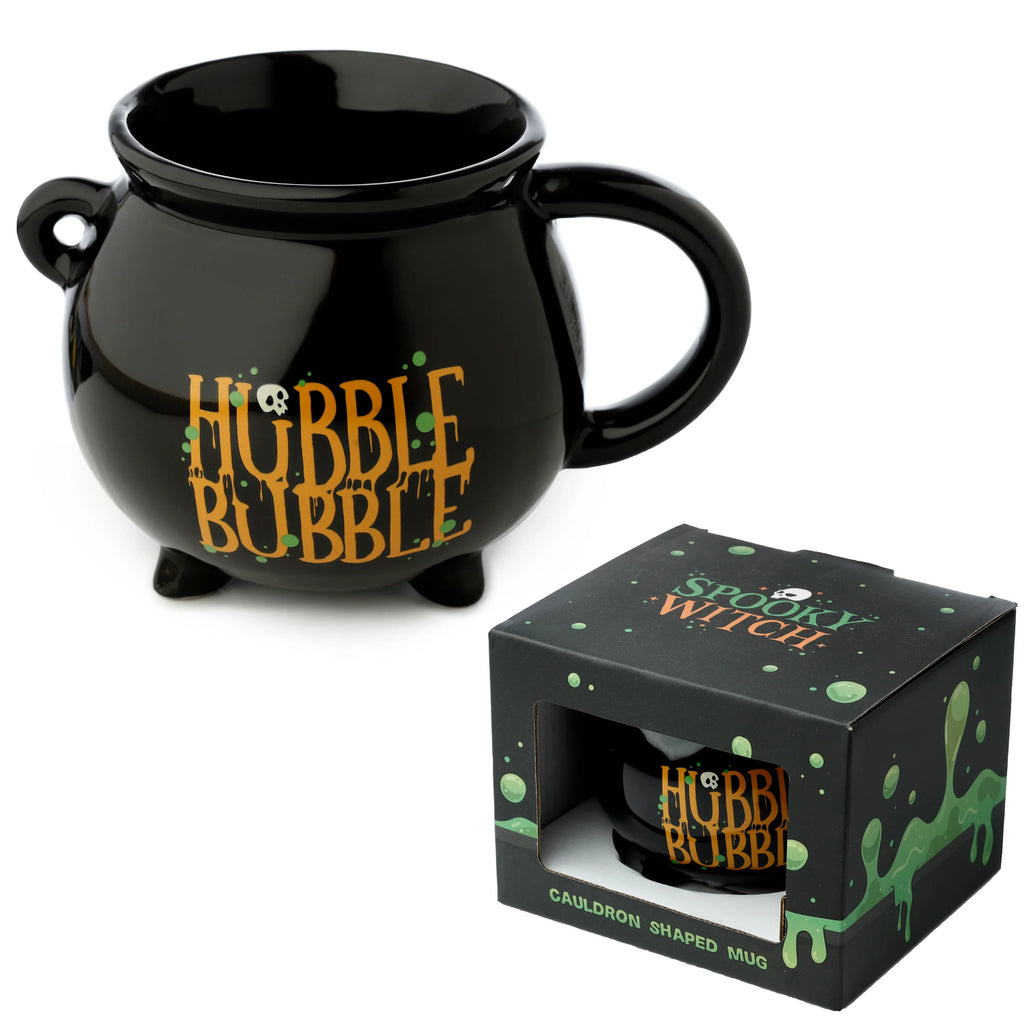 Angled view of a black ceramic cauldron-shaped mug with HUBBLE BUBBLE text, a skull, green splatters, and a handle, presented next to its matching Spooky Witch themed gift box.