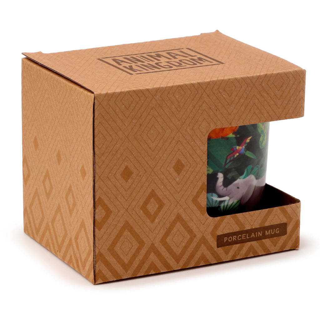 Angled view of a 'Porcelain Mug - Animal Kingdom' with a colourful elephant and tropical bird design, visible through the display window of its natural brown cardboard packaging, which features a geometric pattern, 'ANIMAL KINGDOM' text on top, and 'PORCELAIN MUG' text at the window's base.