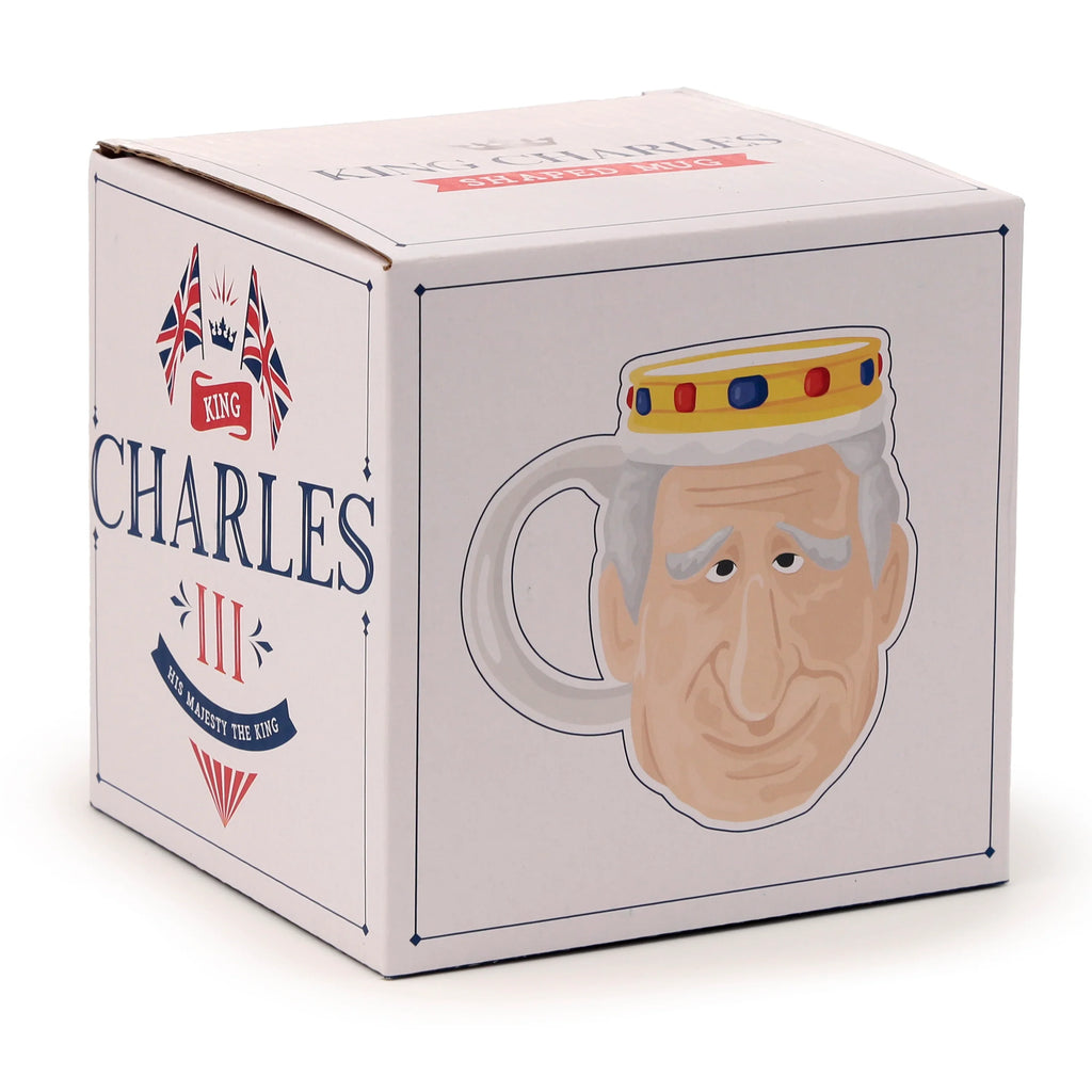 Angled view of white King Charles III ceramic shaped head mug packaging box, featuring a cartoon King Charles III head illustration on one side and 'King Charles III His Majesty The King' text with Union Jack flags on another.
