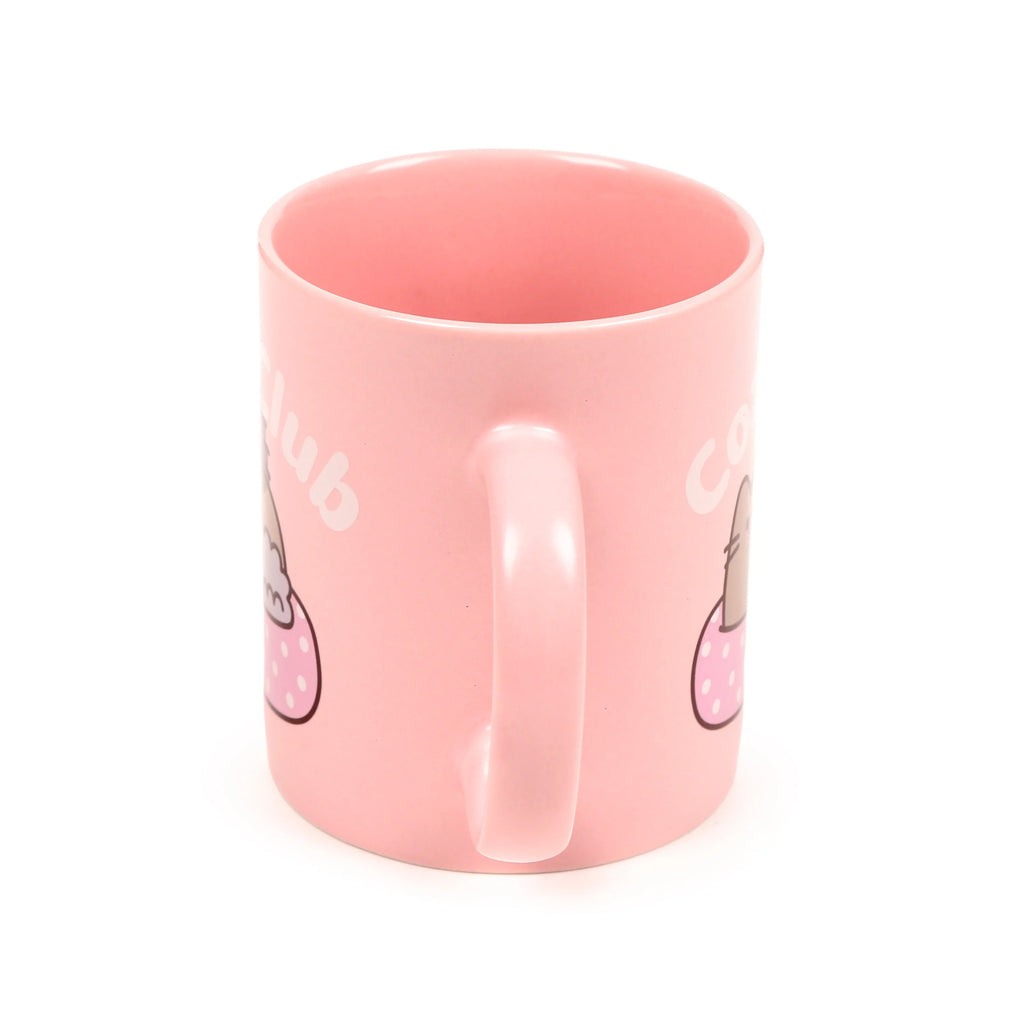 Pink porcelain mug, handle centred, with visible sections of a cartoon cat in a pink spotted cup and 'Cozy Club' lettering.
