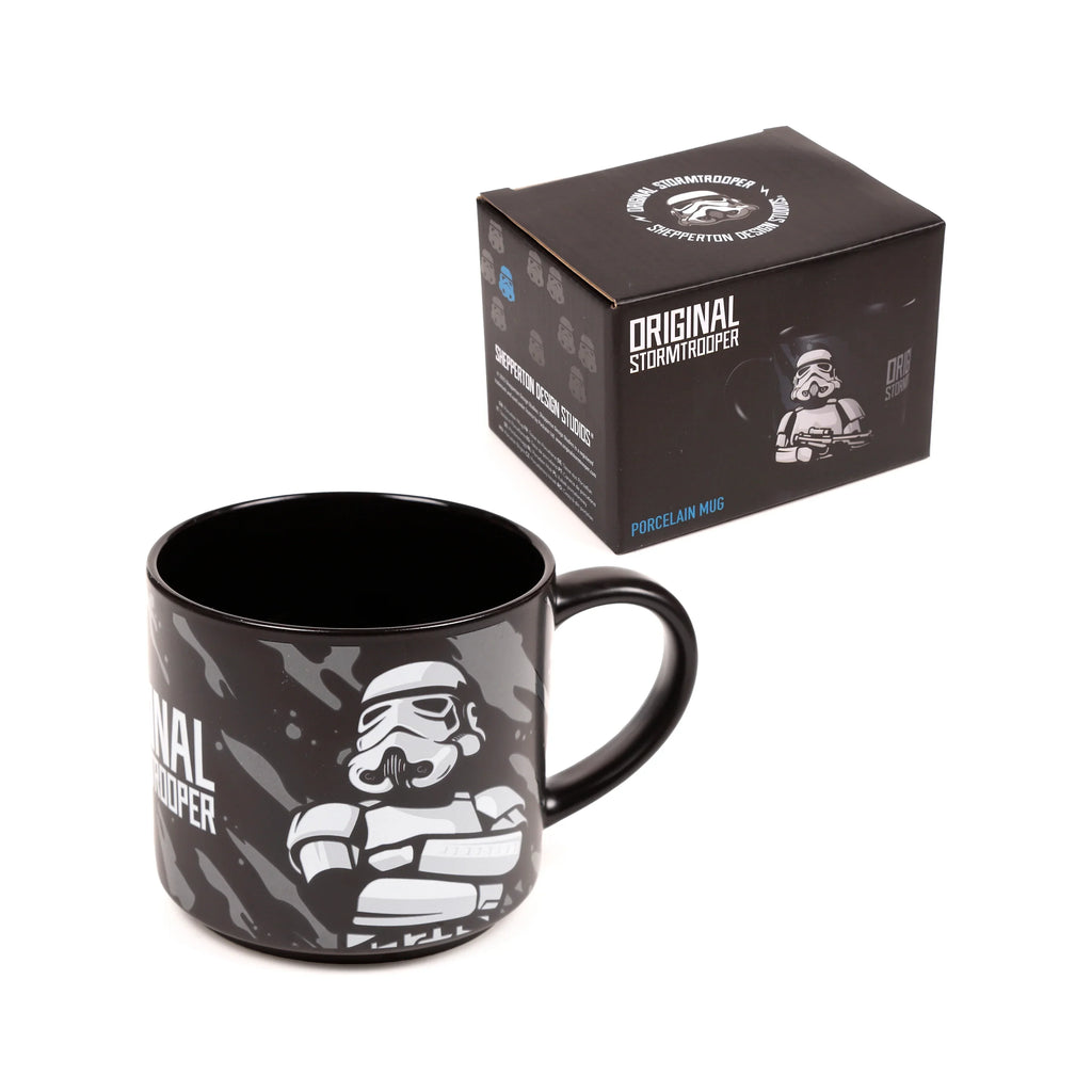 Angled view of a large black porcelain mug with a grey splatter pattern, featuring a white Stormtrooper helmet and 'Original Stormtrooper' text, presented alongside its black gift box with matching Stormtrooper imagery.