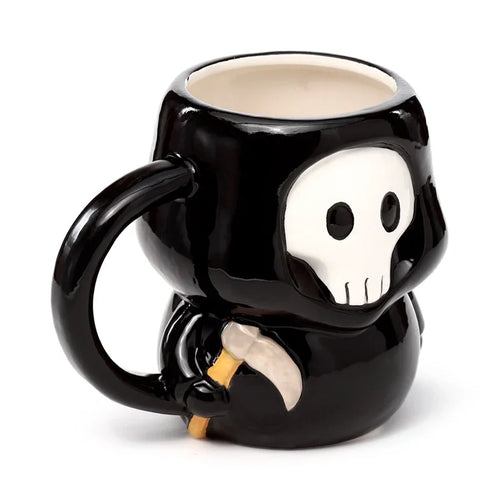 Angled view of a black ceramic novelty mug shaped like a skull boy, depicting a white skull face with black eye sockets and nose, and a beige scythe detail, with a prominent black handle.