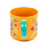 Angled view of a large orange porcelain mug with a teal handle, decorated with colourful Day of the Dead sugar skull designs and patterns.