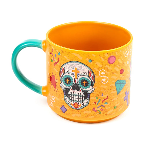 Angled view of an orange Day of the Dead mug, featuring a colourful sugar skull design with a speckled background and a teal handle.