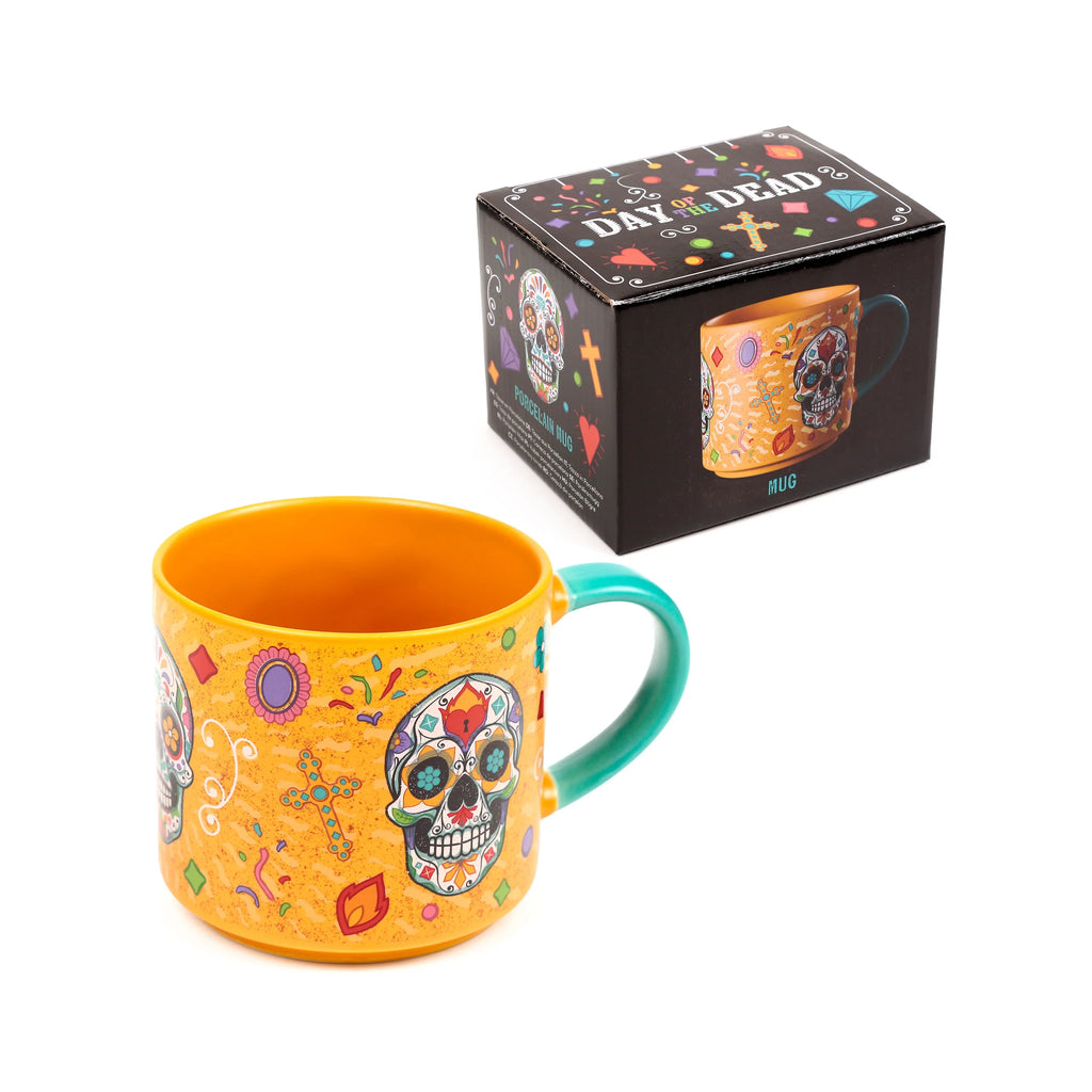 Angled view of a large, orange porcelain mug featuring colourful Day of the Dead sugar skull designs and a prominent turquoise handle, with its matching black gift box in the background.