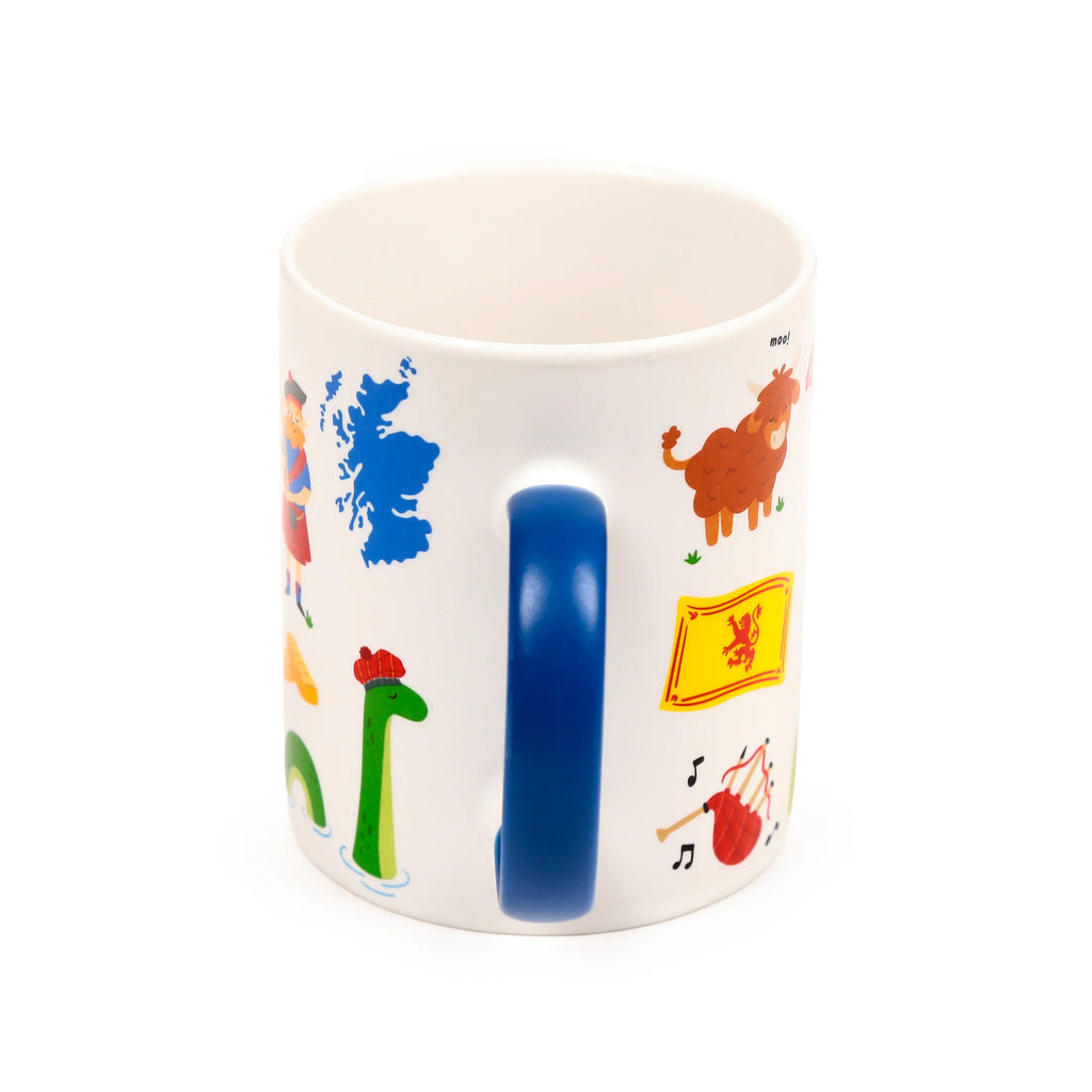 Angled view of a white porcelain Scotland souvenir mug with a blue handle, decorated with colourful cartoon illustrations of Scottish symbols: a map, Nessie, a Highland cow, and the Scottish flag.