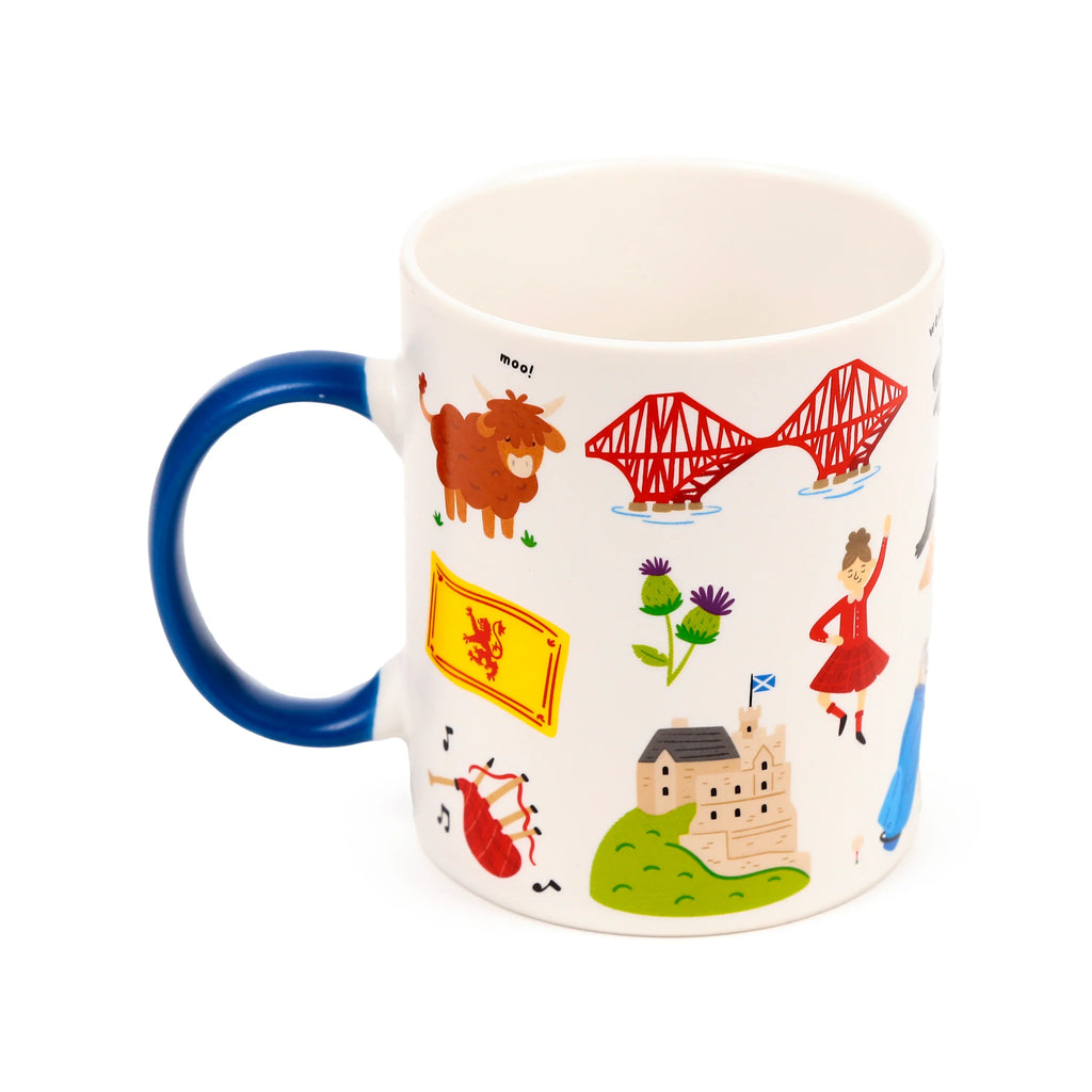 Angled view of a white porcelain Scotland souvenir mug with a blue handle, depicting a Highland cow, Forth Bridge, Scottish flag, thistles, and a castle.