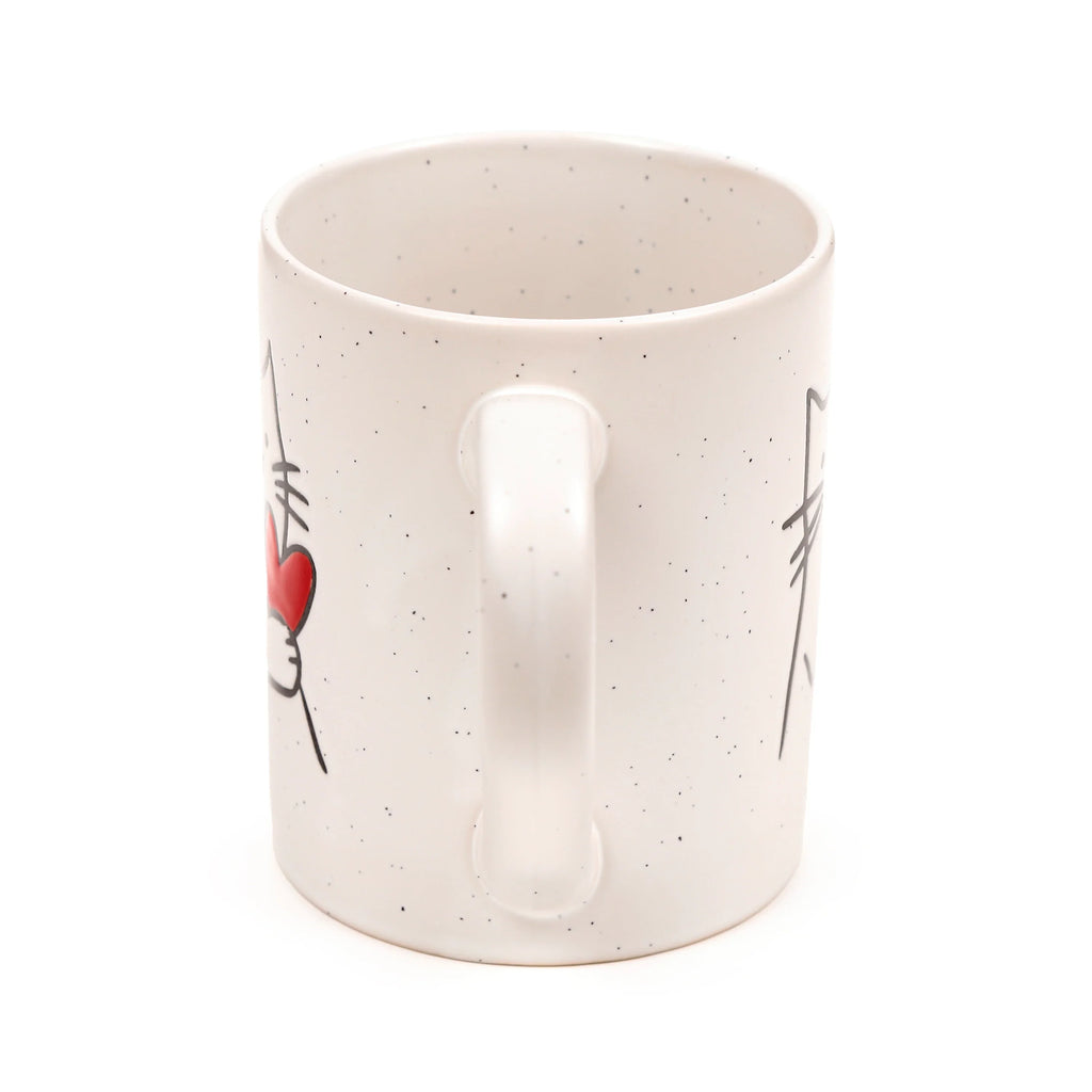 Cream speckled stoneware mug showing the handle, decorated with a stylised black cat outline and a red heart.