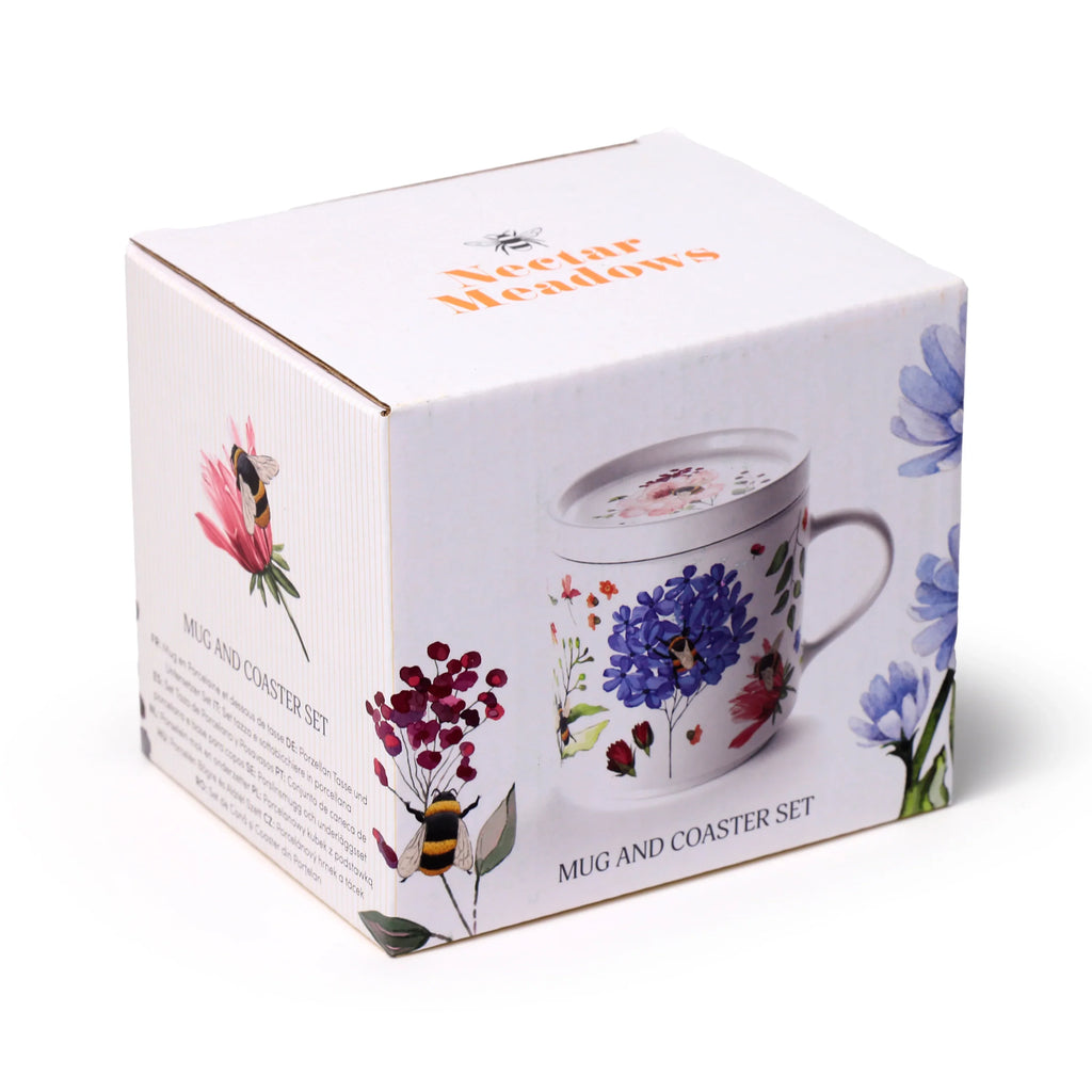 Angled view of the white packaging for a Nectar Meadows Porcelain Mug and Coaster Lid Set, featuring colourful floral and bee designs.