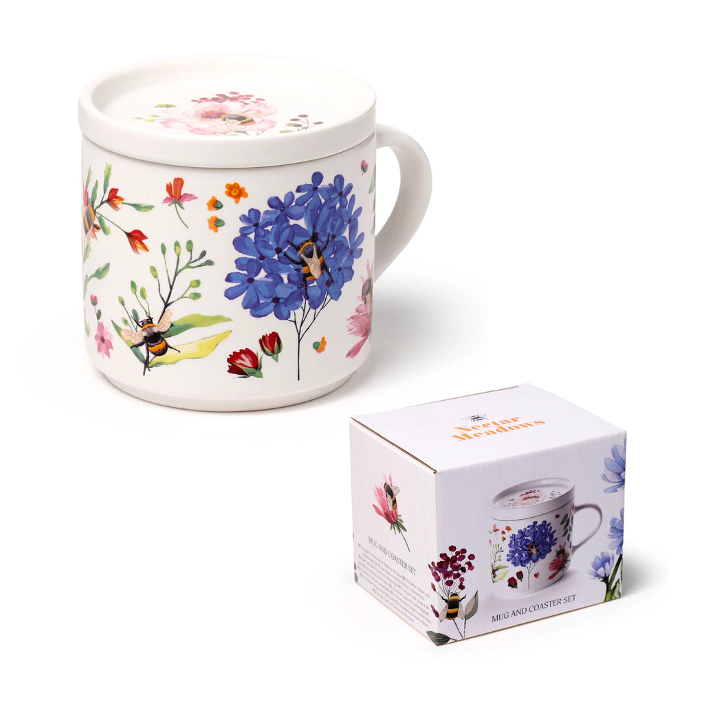 Angled view of a white porcelain mug with a colourful floral and bee pattern, featuring a matching coaster lid, placed next to its white 'Nectar Meadows' product box adorned with the same design.
