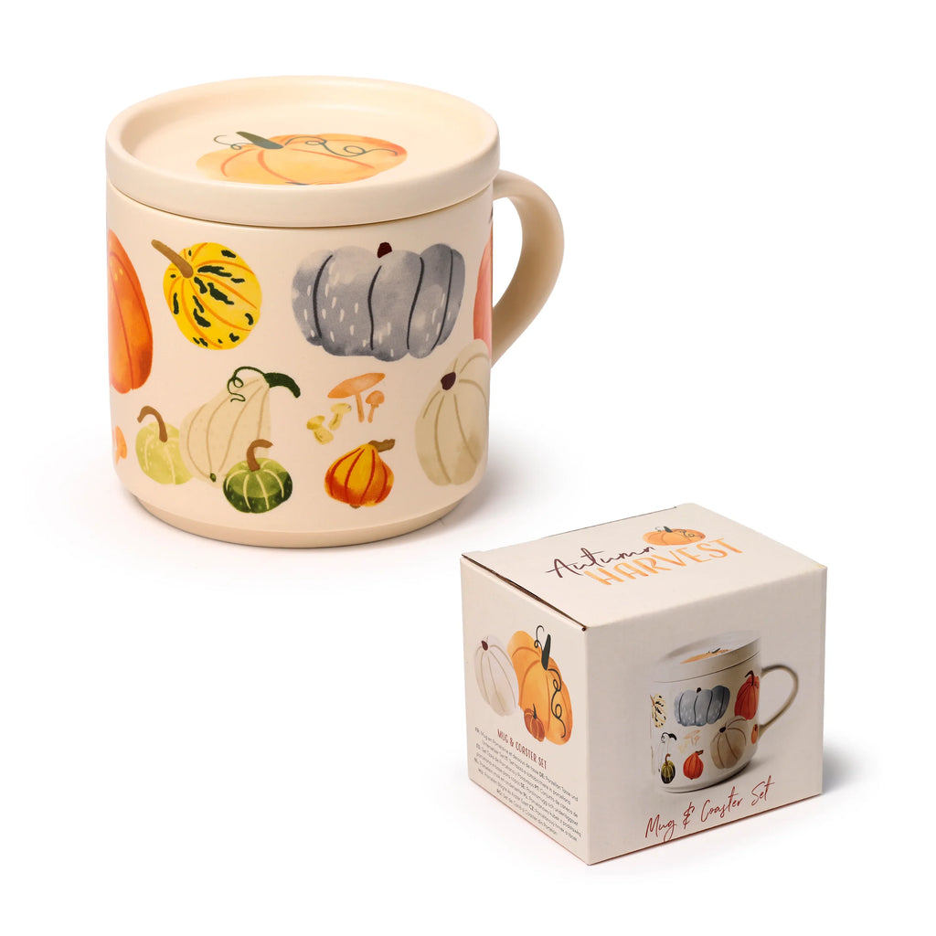 Angled view of a cream porcelain mug and coaster lid, adorned with colourful autumn harvest pumpkin and gourd illustrations, displayed alongside its matching product box.