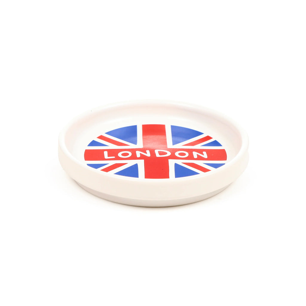 Angled view of a white porcelain coaster lid, decorated with a Union Flag design and 'LONDON' text.
