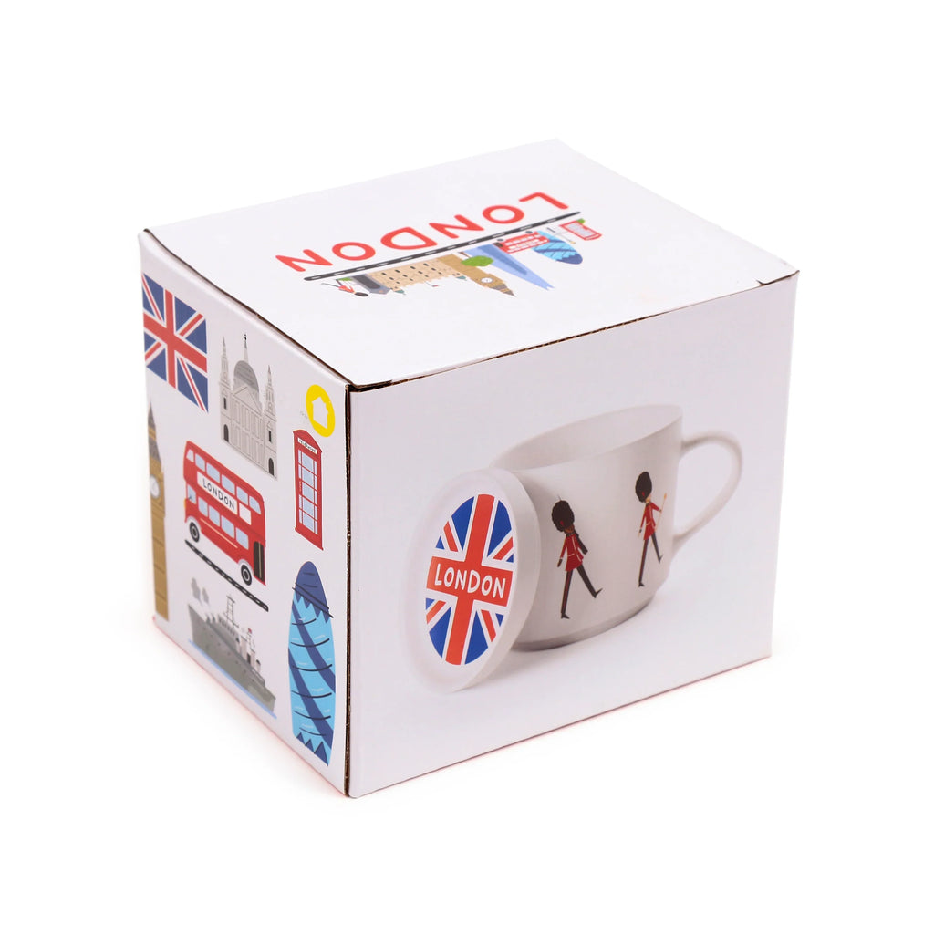 Angled view of a white product box for a London souvenir porcelain mug and coaster lid set. The box is adorned with various London landmarks, a Union Jack flag, and a graphic of the white mug featuring London Guardsmen, alongside a Union Jack coaster.