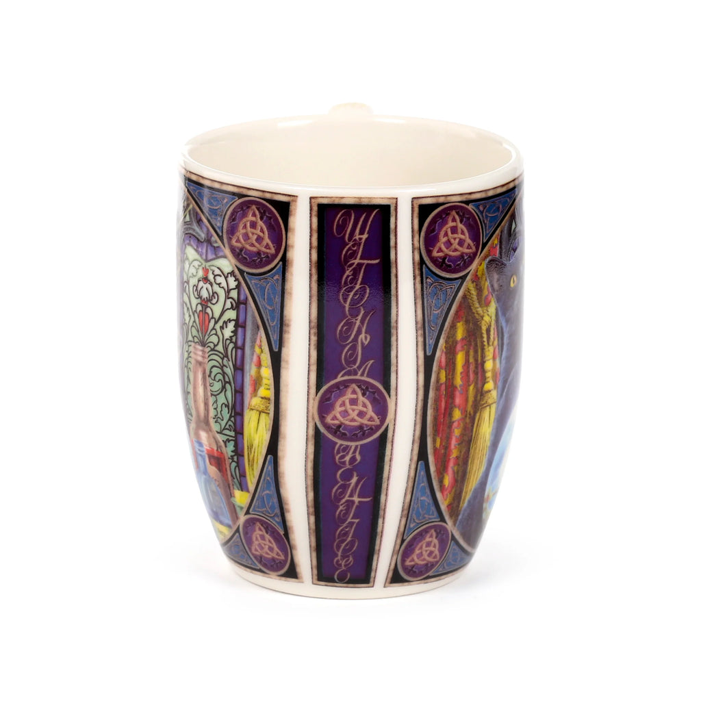 Angled view of a porcelain mug with a colourful wraparound design featuring a central purple panel spelling 'WITCH' in decorative script, flanked by triquetra symbols, and showing parts of a black witch's apprentice cat and a broomstick.