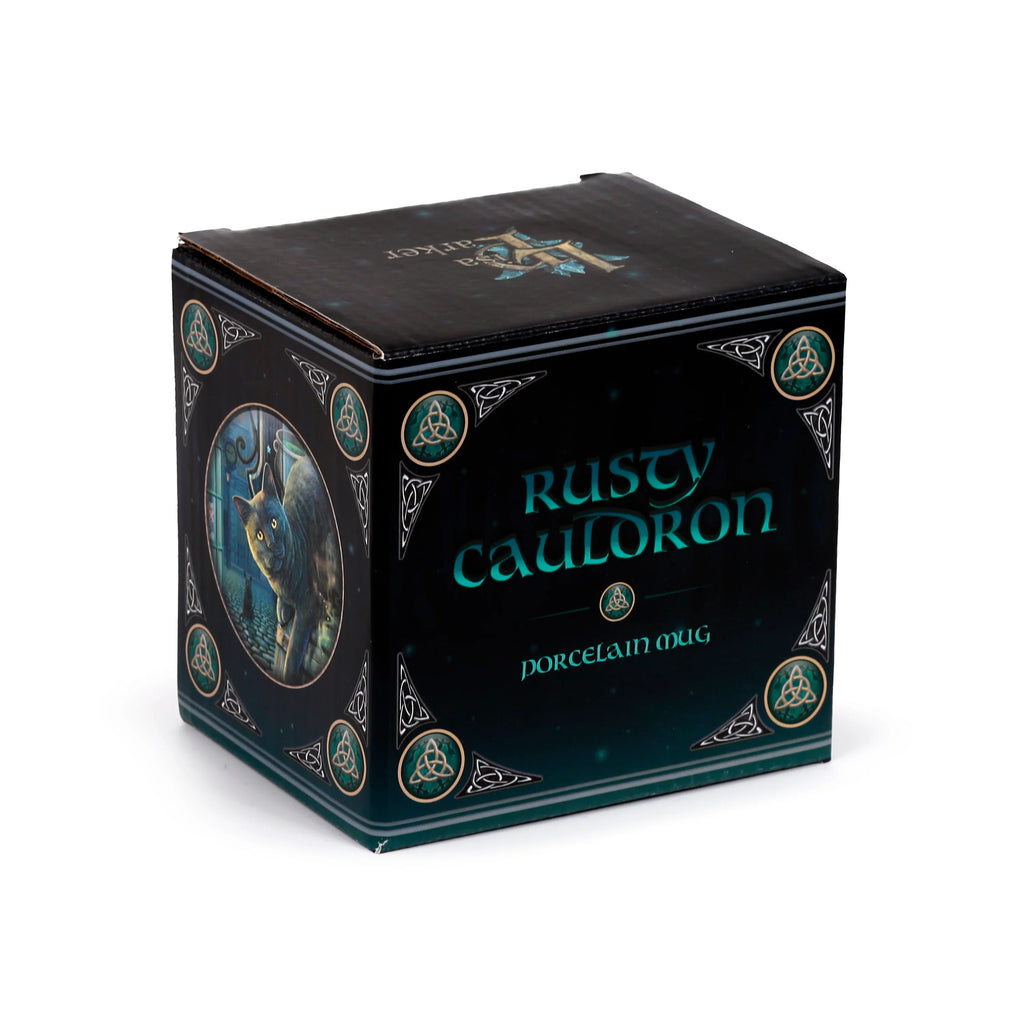 Angled view of a dark blue-green porcelain mug gift box, featuring 'Rusty Cauldron' text and a black cat illustration in an oval frame, with Celtic knot designs.