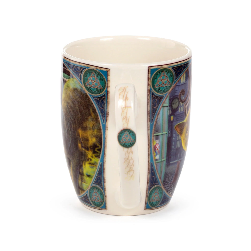 Porcelain mug, viewed from an angle highlighting its decorative handle and portions of the 'Rusty Cauldron Cat' artwork, framed by blue and green Celtic patterns.