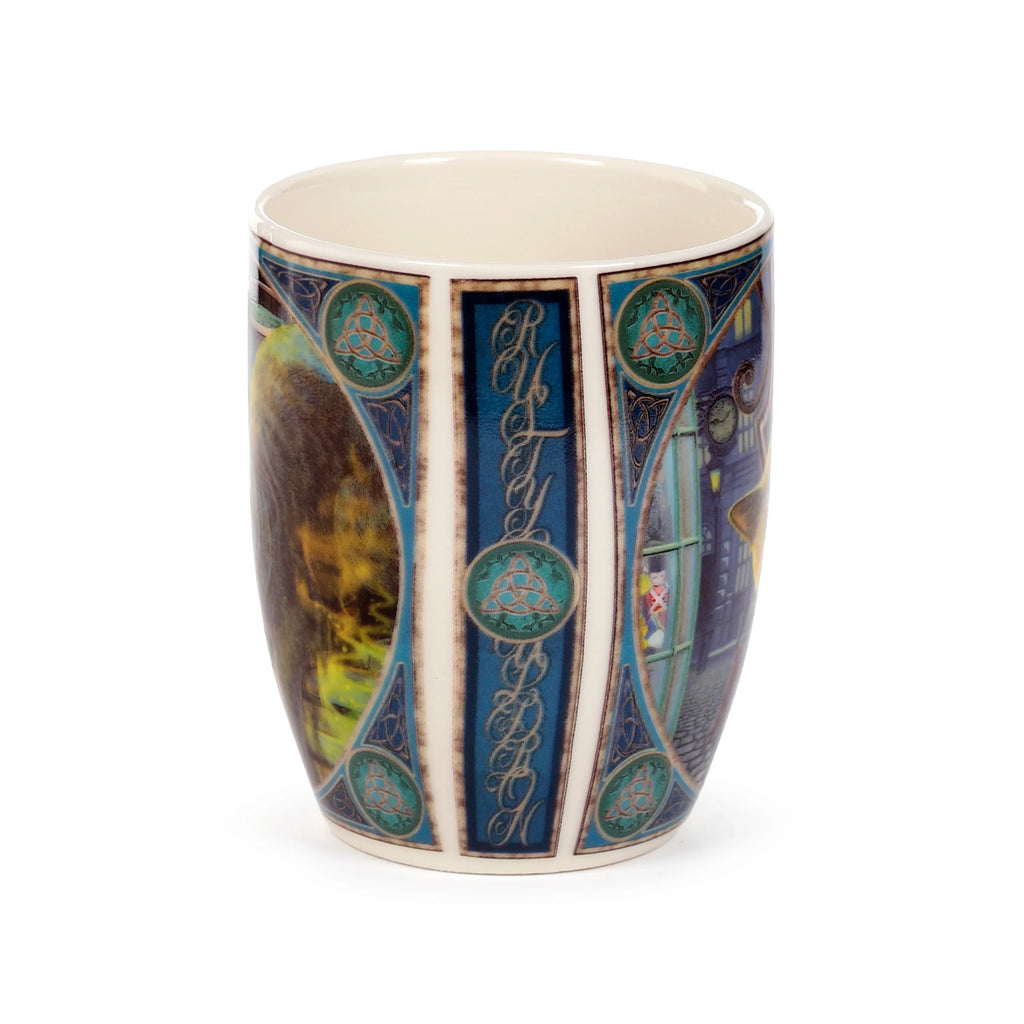 Angled view of a porcelain mug with a decorative print, showing a central blue panel featuring 'Rusty' script and Celtic knotwork, flanked by a feline illustration and a street scene with illuminated windows.