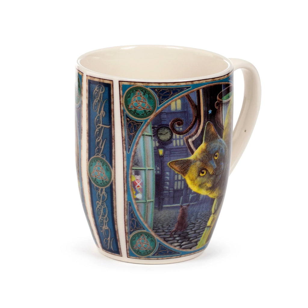 Angled view of a porcelain mug featuring the 'Lisa Parker Rusty Cauldron Cat' design, depicting a large, yellow-eyed cat peering from a nocturnal alleyway scene with a smaller cat on cobblestones and a toy soldier in a window. The illustration is bordered by ornate blue and green Celtic knot patterns, with an off-white handle and interior.