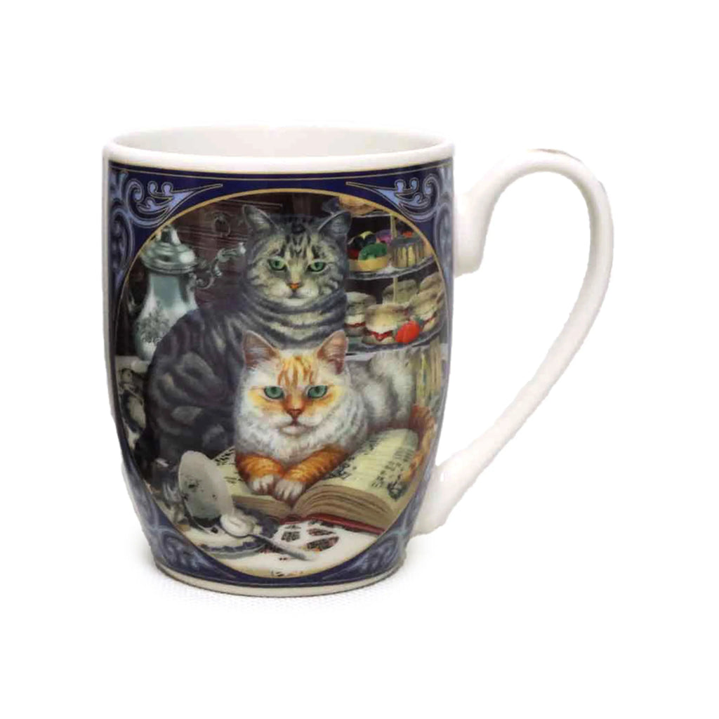 Angled view of a white porcelain mug with a navy blue decorative band, illustrating a ginger and white cat with green eyes resting on an open book, a grey tabby cat behind it, a silver teapot, and colourful cakes.